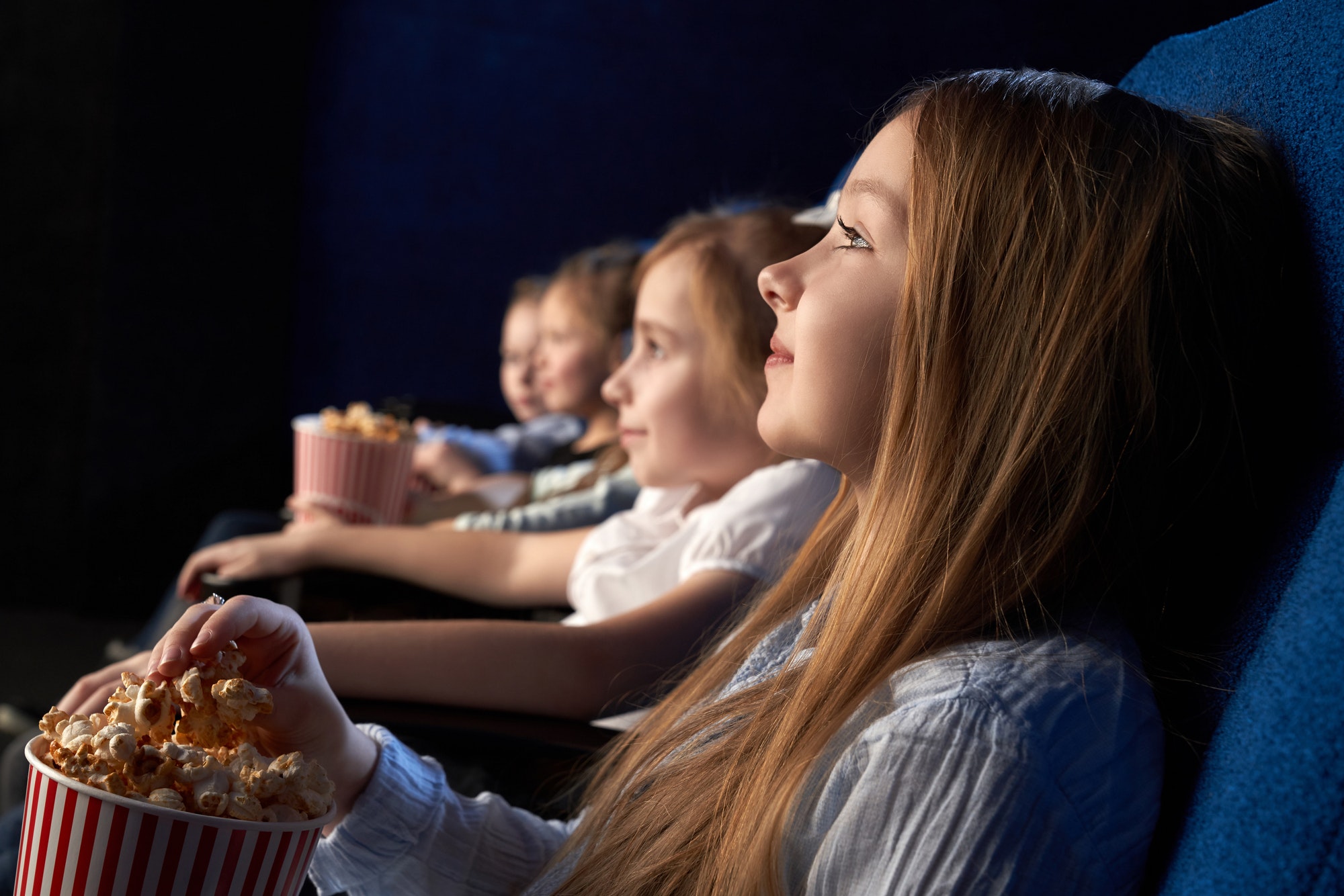 Children watching movie in cinema theatre